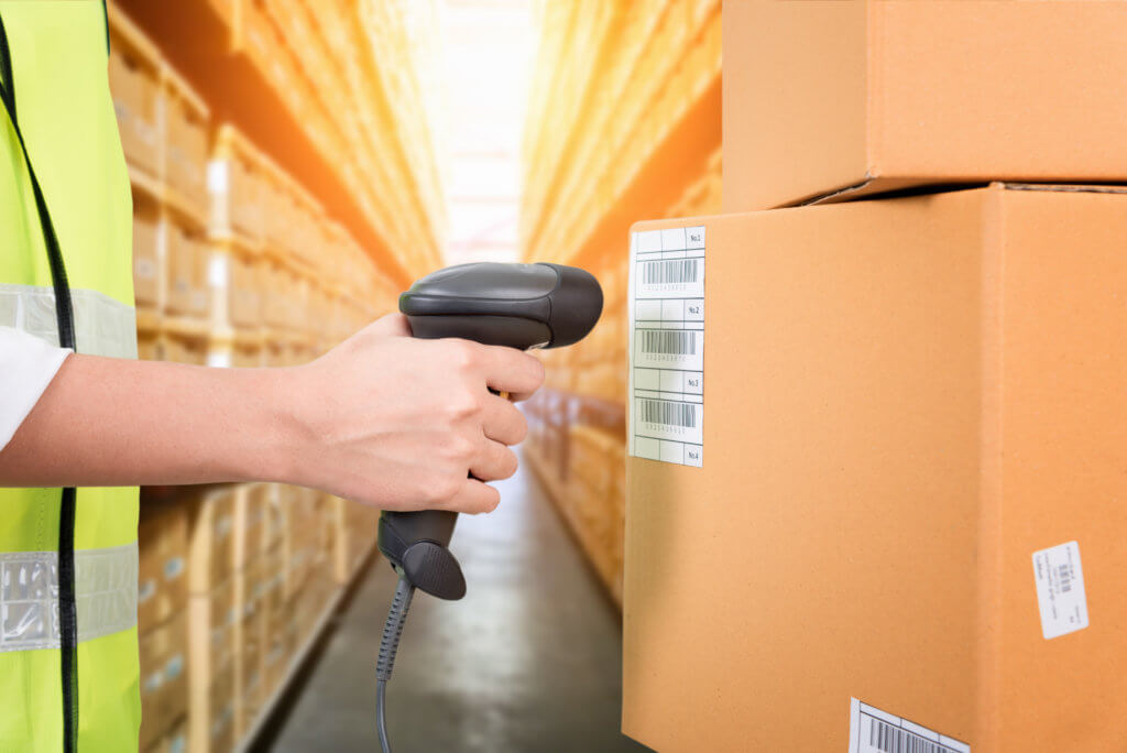 hand holding scanner towards barcoded label