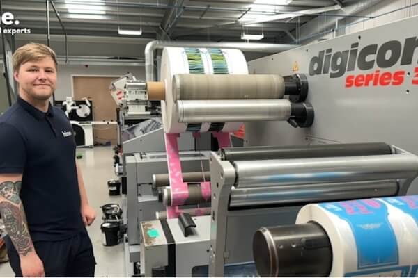 tom standing beside printing machine