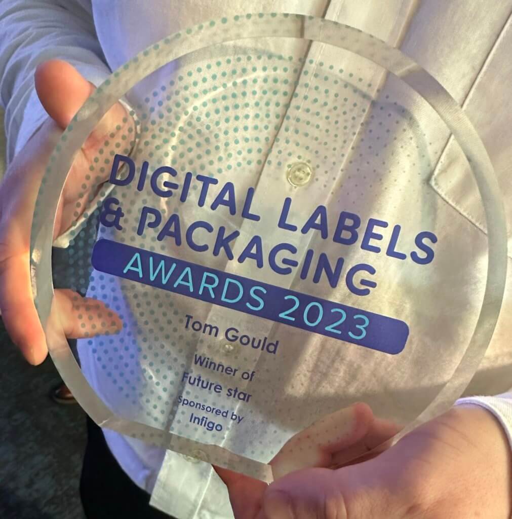 hands holding trophy for Digital Labels and Packaging Awards 2023